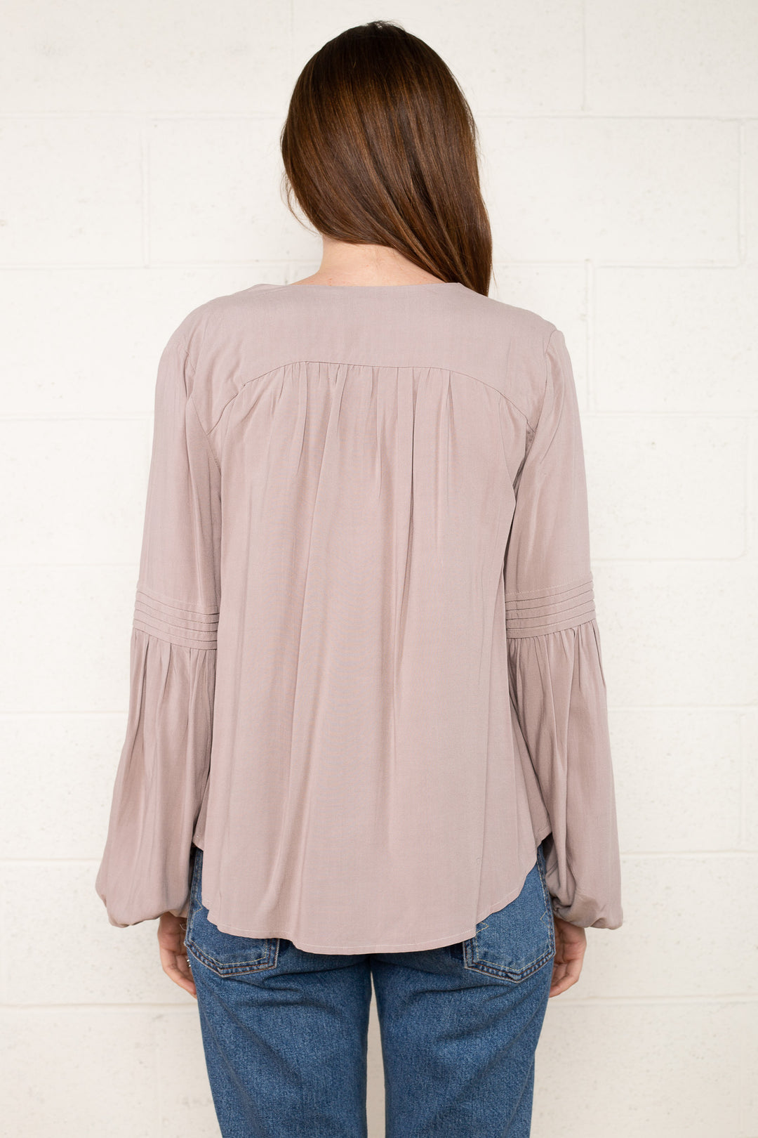 Ariella Pintuck Flare Sleeve Top by NLT: Chic long sleeve blouse with intricate pin-tucking and trendy flare sleeves. Versatile style for day-to-night transitions, blending sophistication and comfort seamlessly.