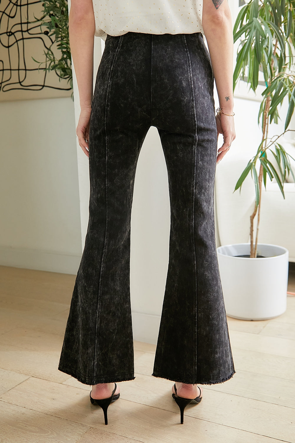 Angelica High Waist Crop Flare Jeans by Mystree: Elevate your style with these mineral-washed high waist pants featuring a chic flare hem and eye-catching fringe detail. The side zipper closure ensures a sleek fit, while sophisticated middle seams add modern flair. Explore our collection for trendy bottoms that seamlessly blend comfort and style.
