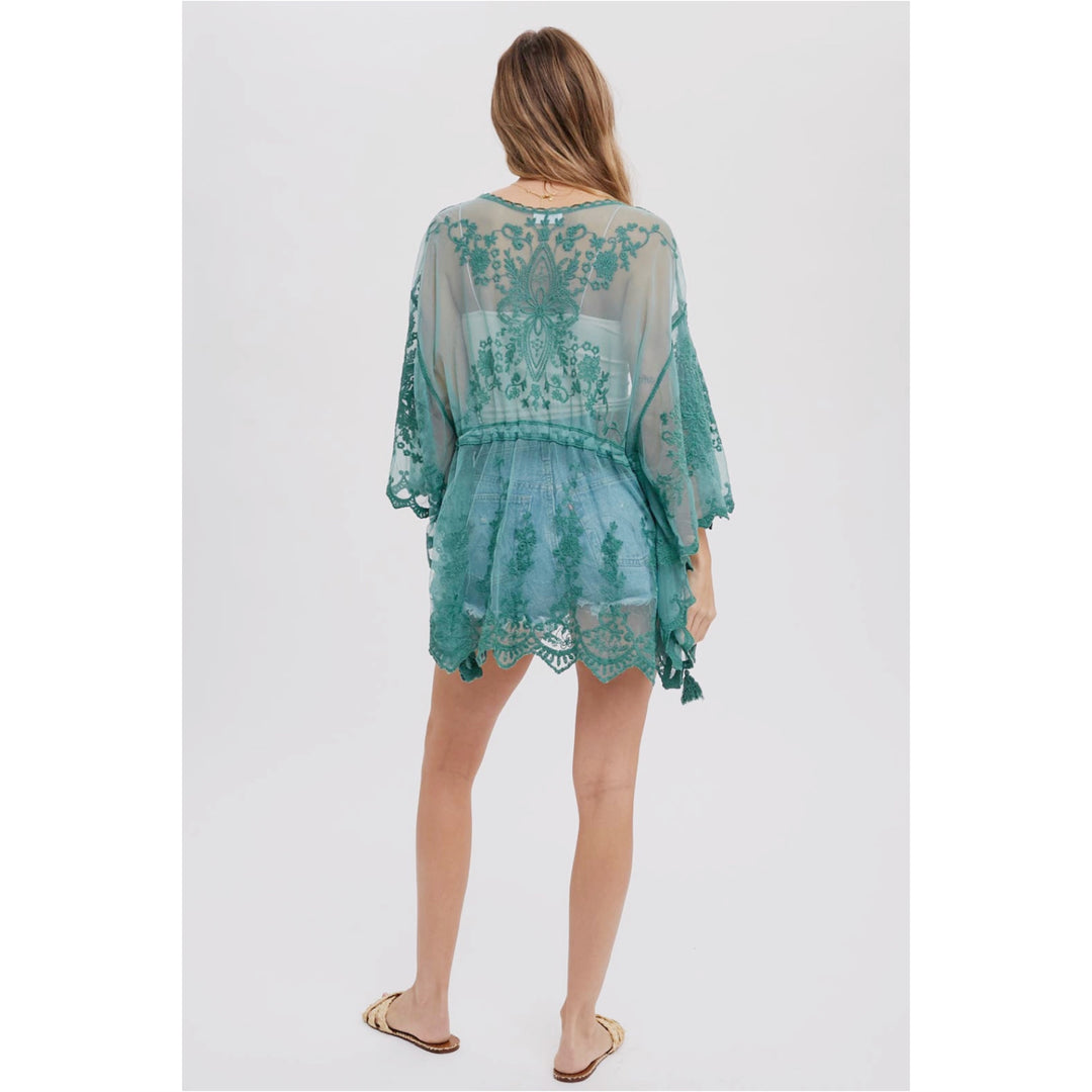 Embroidered Lace Kimono: Open-front, 3/4 wide bell sleeves, scalloped hemline, and waist tie string with tassel. Versatile and stylish for layering, pairing with a maxi dress, or as a beach cover-up. Elevate your wardrobe with this chic and fashionable kimono.