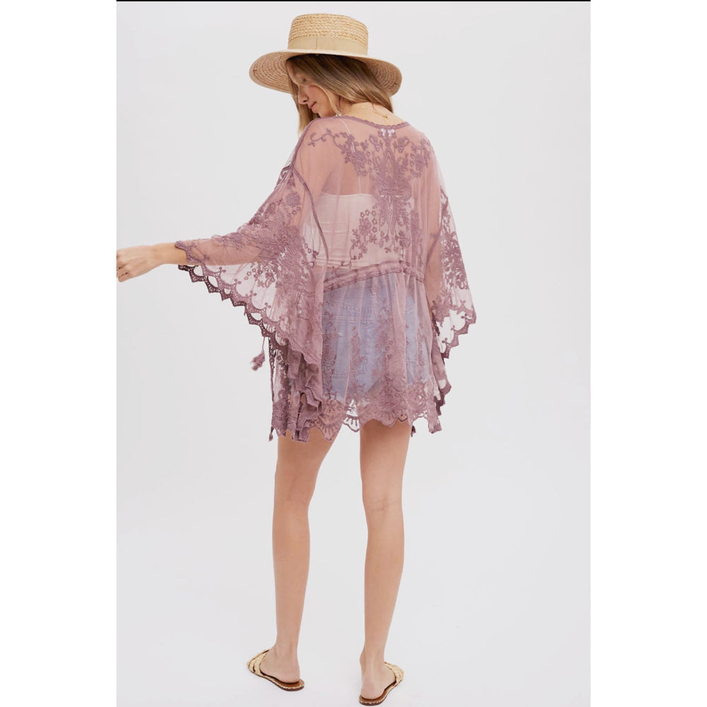Short Embroidered Kimono: Open-front design, 3/4 wide bell sleeves, scalloped hemline, and waist tie string with tassel. Versatile and stylish for layering, pairing with a maxi dress, or as a beach cover-up. Elevate your style with this chic and comfortable kimono.