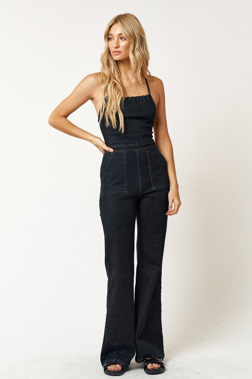 Blue Blush Denim Lace-Up Open Back Jumpsuit: Denim bell-bottom jumpsuit with side pockets and a sexy lace-up open back. A fusion of comfort and allure for a bold statement at any occasion. Chic and playful design, a must-have for a versatile wardrobe.