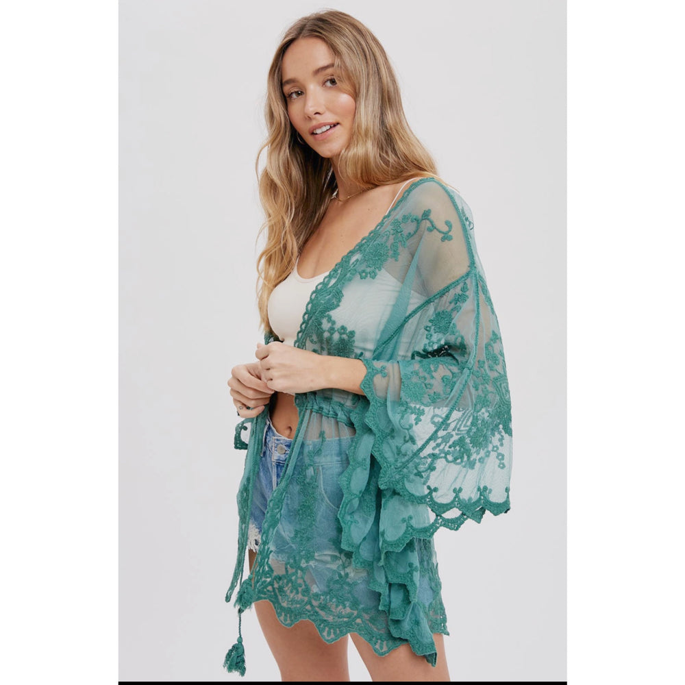 Embroidered Lace Kimono: Open-front, 3/4 wide bell sleeves, scalloped hemline, and waist tie string with tassel. Versatile and stylish for layering, pairing with a maxi dress, or as a beach cover-up. Elevate your wardrobe with this chic and fashionable kimono.